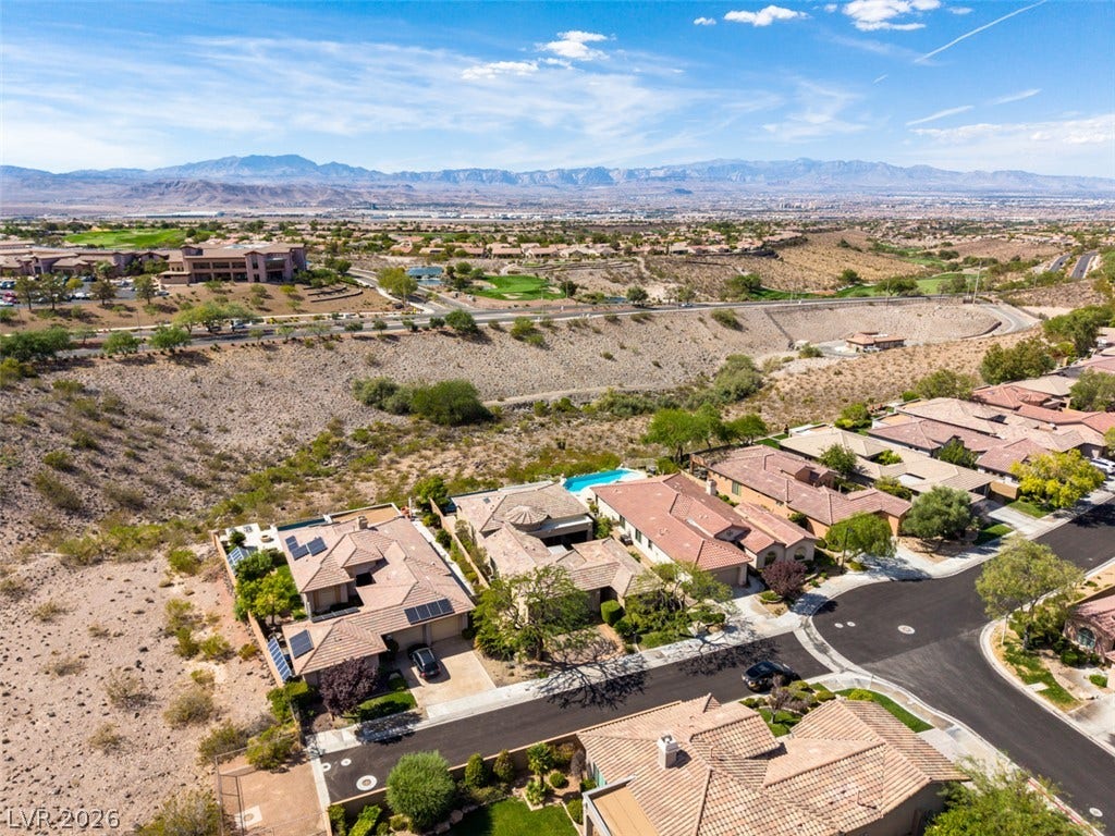 51 E Braelinn Drive, Henderson, NV 89052 An aerial perspective showcases a quiet desert neighborhood nestled against a vast mountain backdrop.