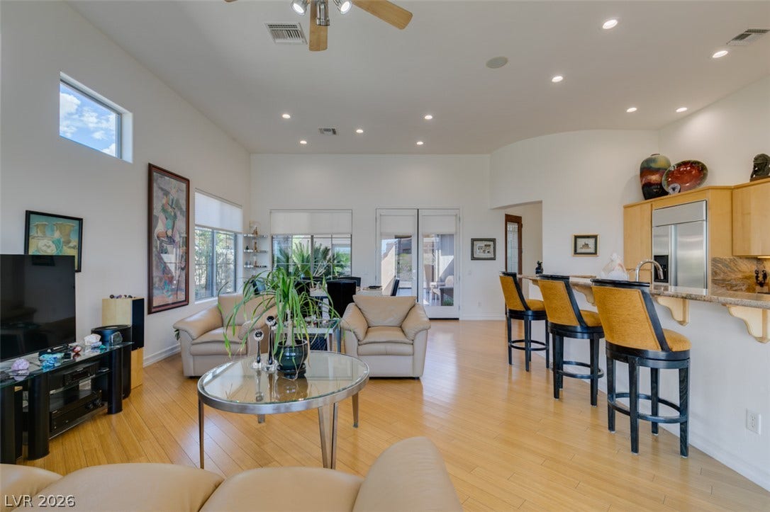 51 E Braelinn Drive, Henderson, NV 89052 Gleaming hardwood floors and a spacious open layout flow seamlessly into the adjacent kitchen.