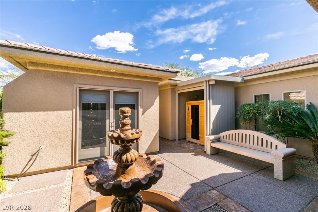 51 E Braelinn Drive, Henderson, NV 89052 An inviting courtyard features textured stucco exterior walls and a classic tiered fountain.