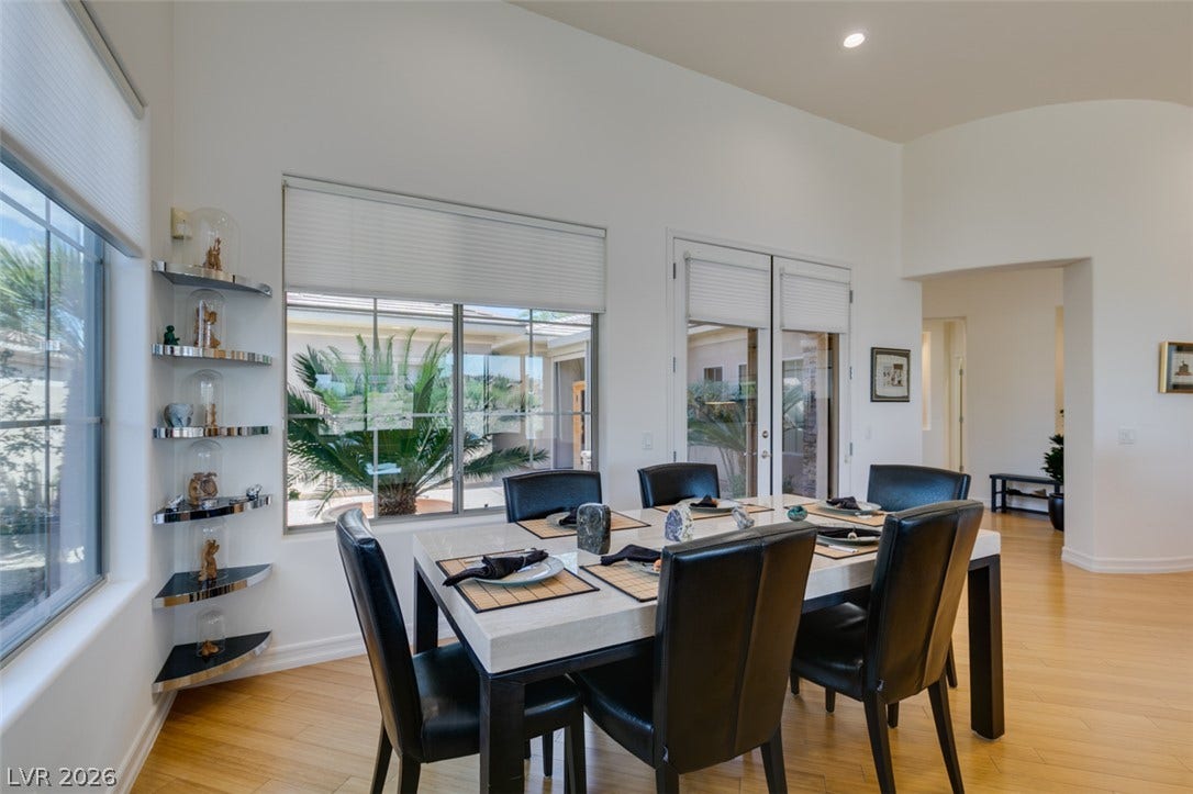 51 E Braelinn Drive, Henderson, NV 89052 High ceilings and warm wood floors define this light-filled dining space.