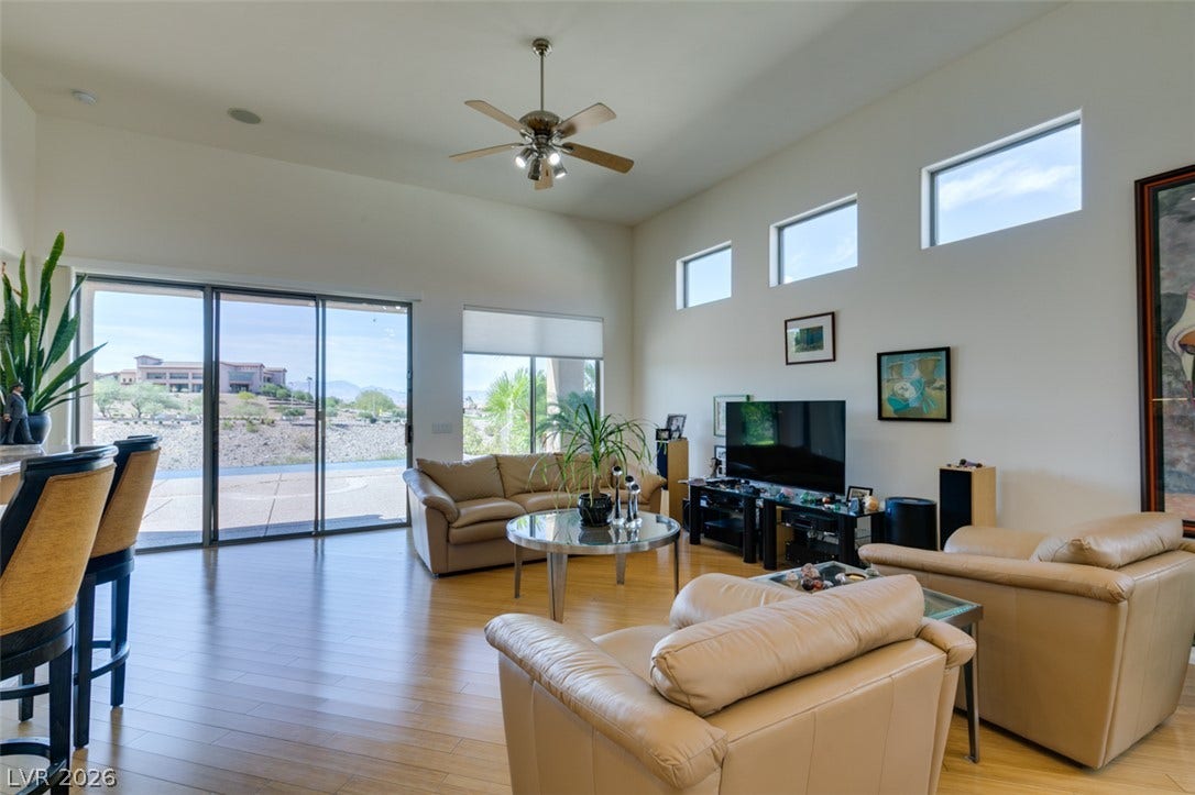 51 E Braelinn Drive, Henderson, NV 89052 High ceilings and gleaming wood flooring define this airy living space with walls of glass.
