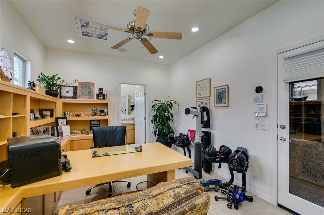 51 E Braelinn Drive, Henderson, NV 89052 Recessed lighting and warm wood built-ins define this functional home workspace.