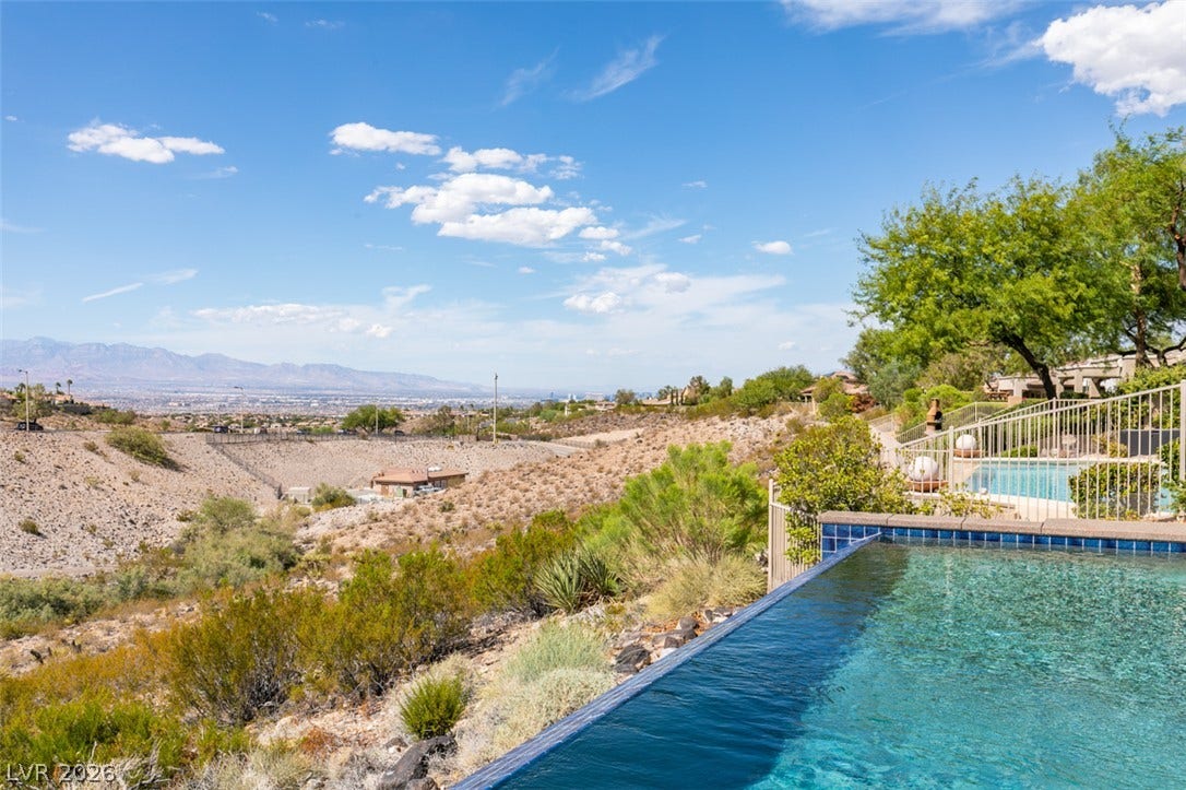 51 E Braelinn Drive, Henderson, NV 89052 An infinity pool looks out over sweeping desert slopes and distant mountain ranges.