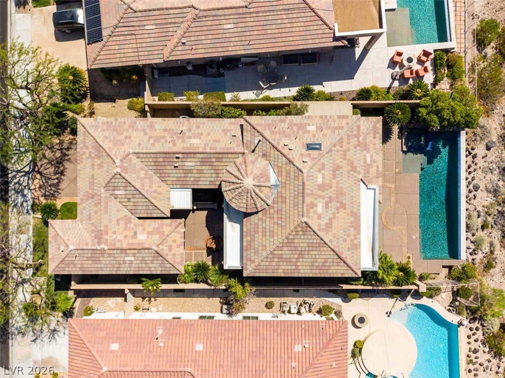 51 E Braelinn Drive, Henderson, NV 89052 An aerial perspective showcases the tiled rooflines alongside a sparkling pool.