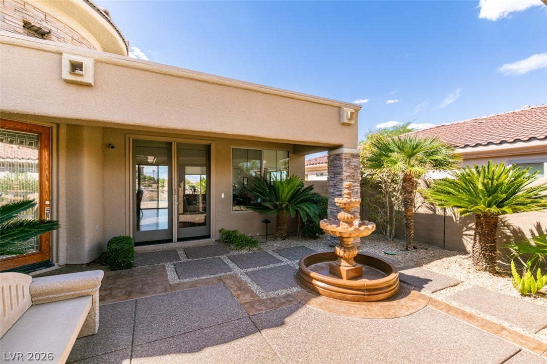 51 E Braelinn Drive, Henderson, NV 89052 An elegant water fountain centers this secluded courtyard patio surrounded by mature palms.