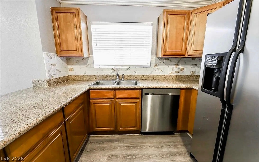 2700 N Rainbow Boulevard, #2137, Las Vegas, NV 89108 Warm wood cabinetry pairs with stone countertops in this functional workspace.