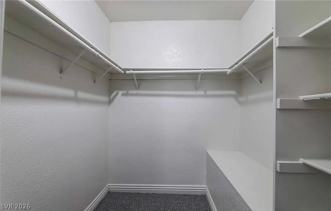 2700 N Rainbow Boulevard, #2137, Las Vegas, NV 89108 Ample built-in shelving and hanging rods maximize storage in this walk-in closet with carpet flooring.