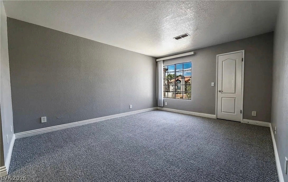 2700 N Rainbow Boulevard, #2137, Las Vegas, NV 89108 Plush carpeting anchors this versatile room under a smooth ceiling with natural window light.