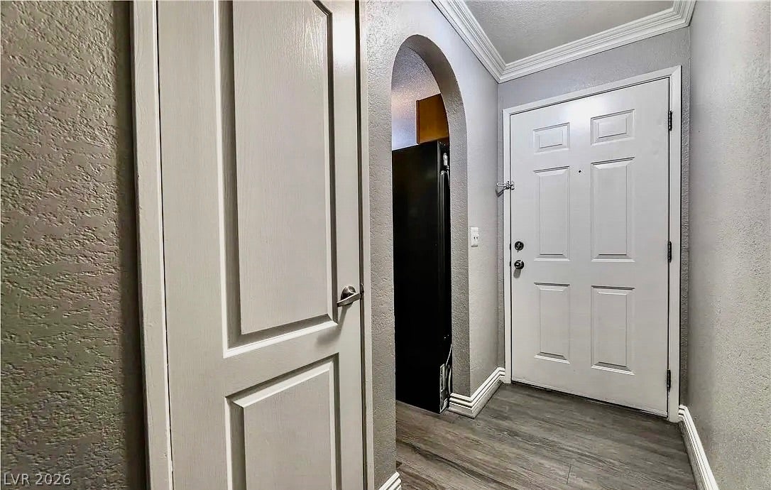 2700 N Rainbow Boulevard, #2137, Las Vegas, NV 89108 An arched doorway and classic crown molding frame this welcoming entry space.
