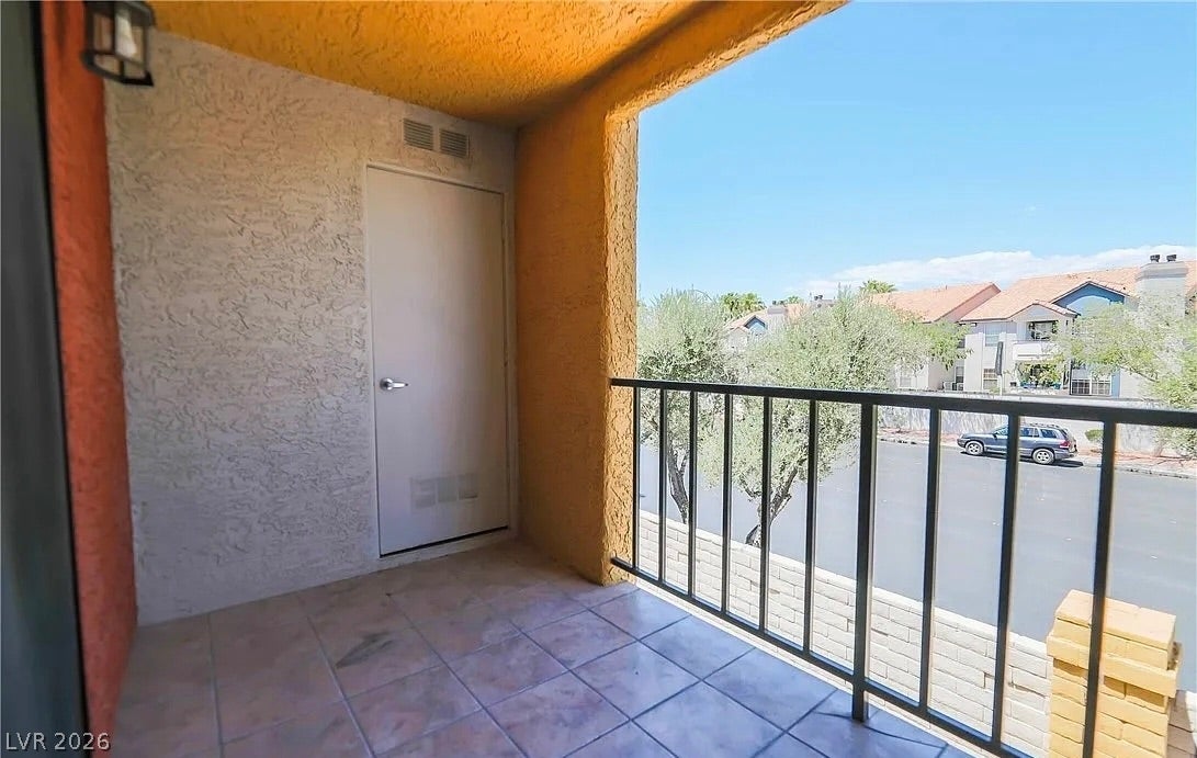 2700 N Rainbow Boulevard, #2137, Las Vegas, NV 89108 A private covered balcony features tile flooring and overlooking views of the neighborhood.