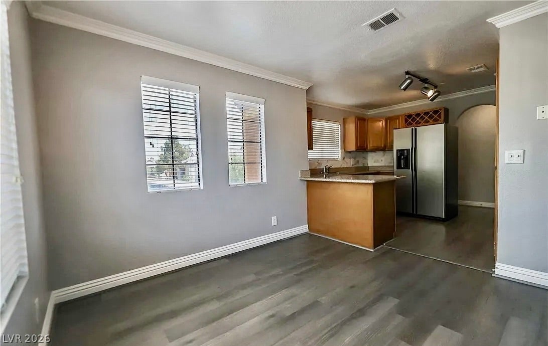 2700 N Rainbow Boulevard, #2137, Las Vegas, NV 89108 Hardwood floors and crown molding enhance this open layout connecting the dining space and kitchen.