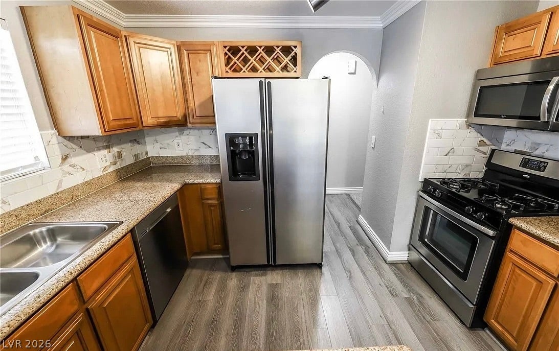 2700 N Rainbow Boulevard, #2137, Las Vegas, NV 89108 Rich wood cabinetry and stone countertops accent this efficient culinary space.