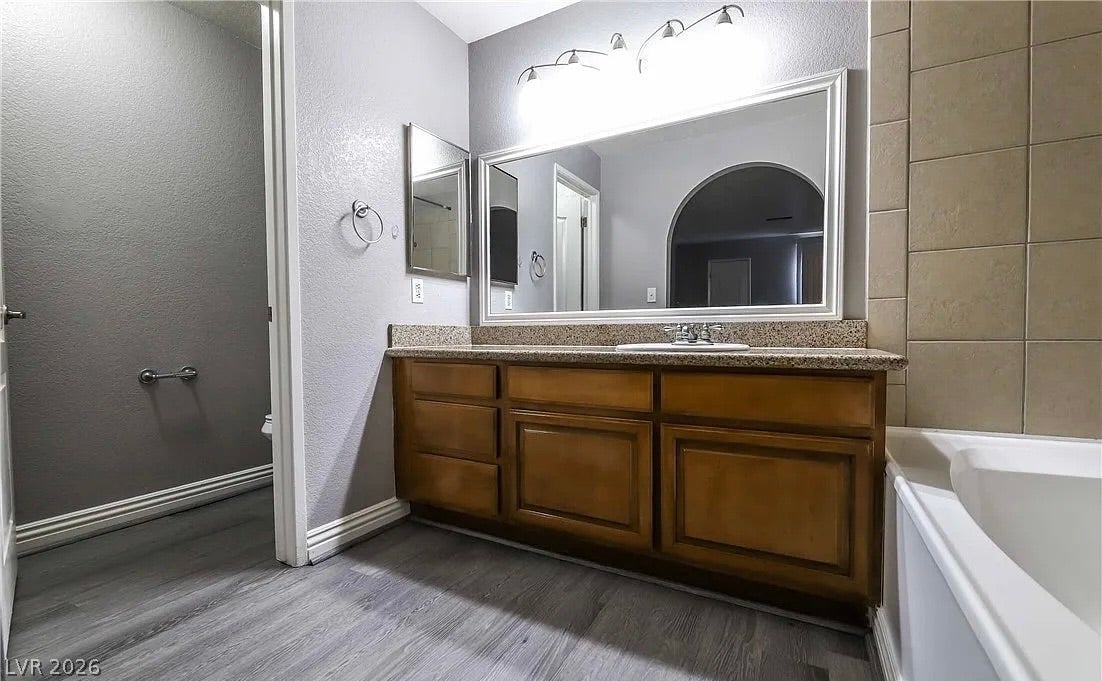 2700 N Rainbow Boulevard, #2137, Las Vegas, NV 89108 An integrated vanity with stone countertops highlights this functional bathroom space.