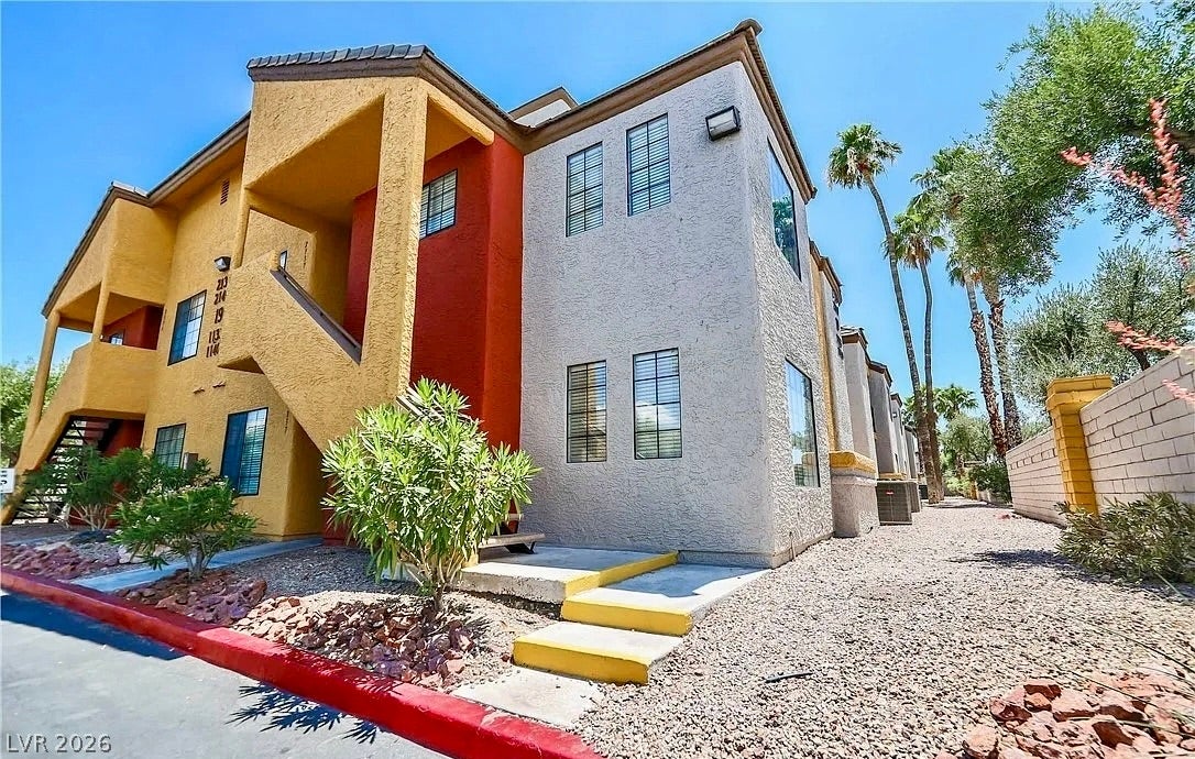 2700 N Rainbow Boulevard, #2137, Las Vegas, NV 89108 Stucco exterior finishes and tile roofing define this multi-level residential building design.