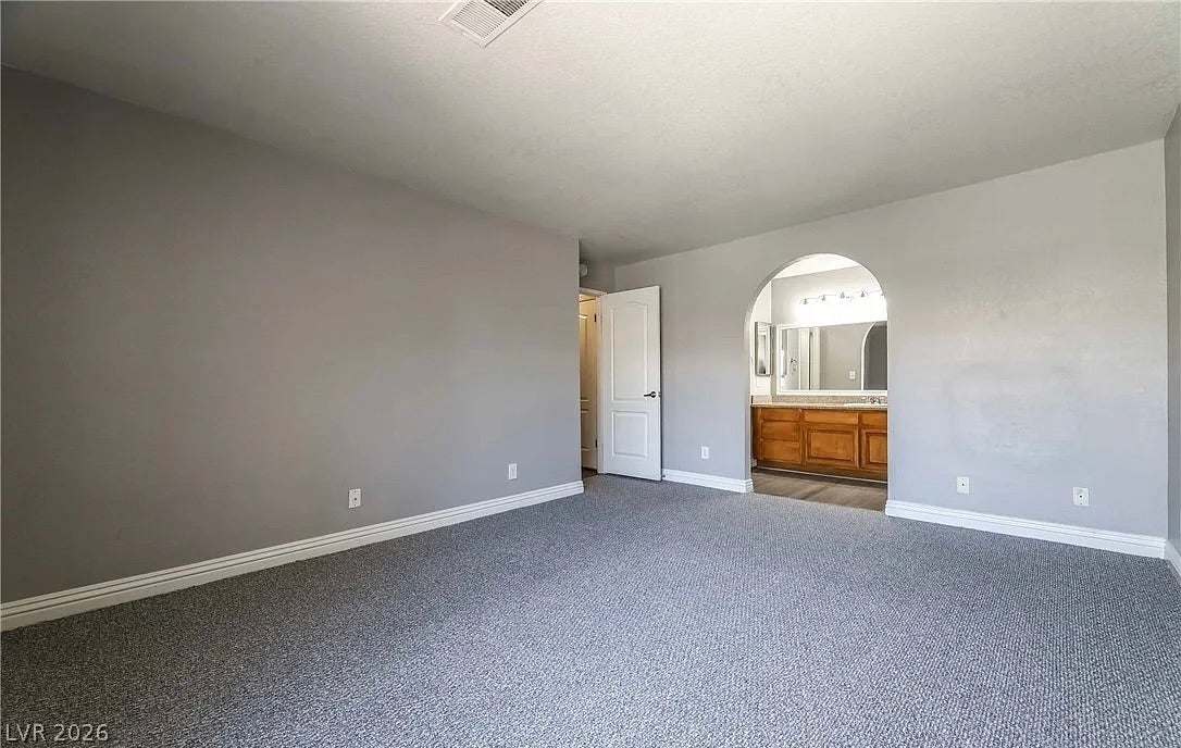 2700 N Rainbow Boulevard, #2137, Las Vegas, NV 89108 An arched doorway connects this spacious bedroom to the adjacent private bathroom suite.