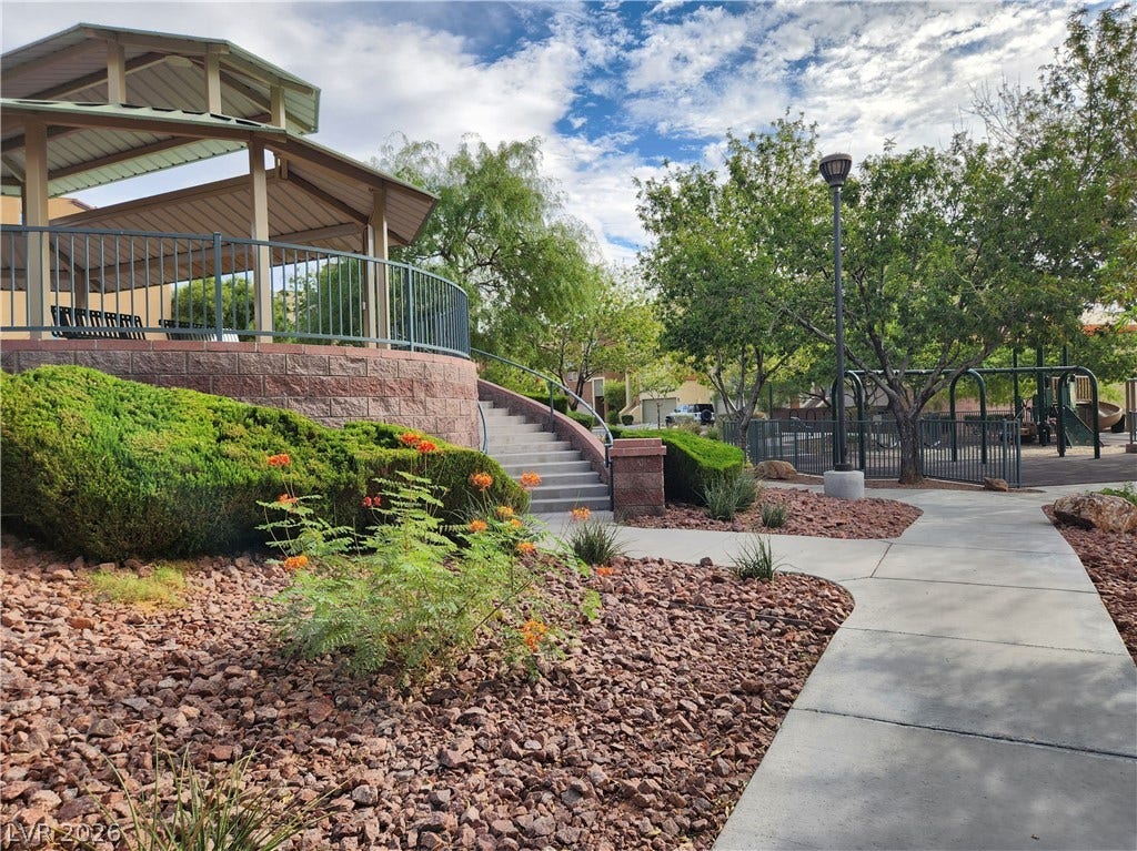 10549 Gibbous Moon Drive, Las Vegas, NV 89129 Concrete walkways meander through community green spaces featuring a shaded gazebo and nearby play area.