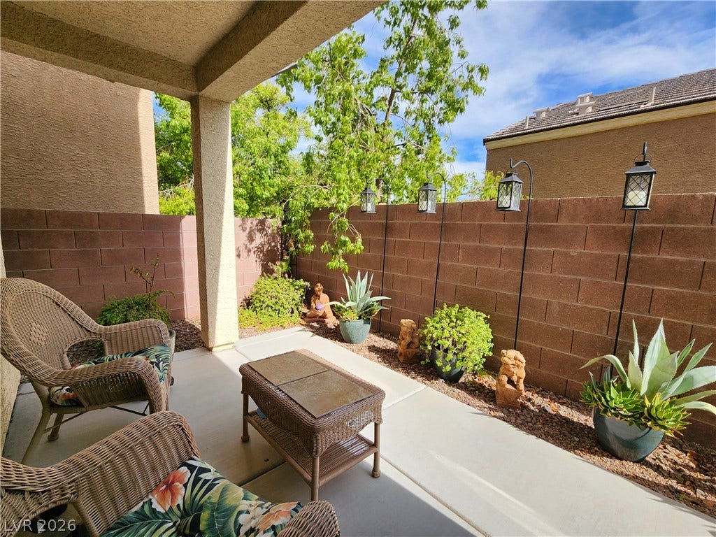 10549 Gibbous Moon Drive, Las Vegas, NV 89129 Concrete paving extends throughout this private rear porch sheltered beneath a covered structure.