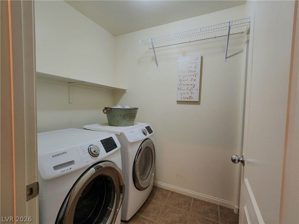 10549 Gibbous Moon Drive, Las Vegas, NV 89129 A functional laundry space incorporates overhead wire shelving alongside durable tile flooring.