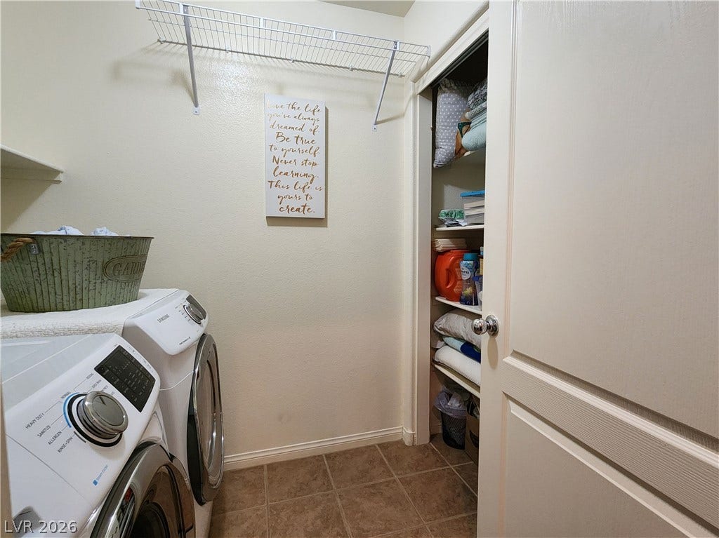 10549 Gibbous Moon Drive, Las Vegas, NV 89129 A functional laundry area includes built-in wire shelving and a double sided linen/storage closet.