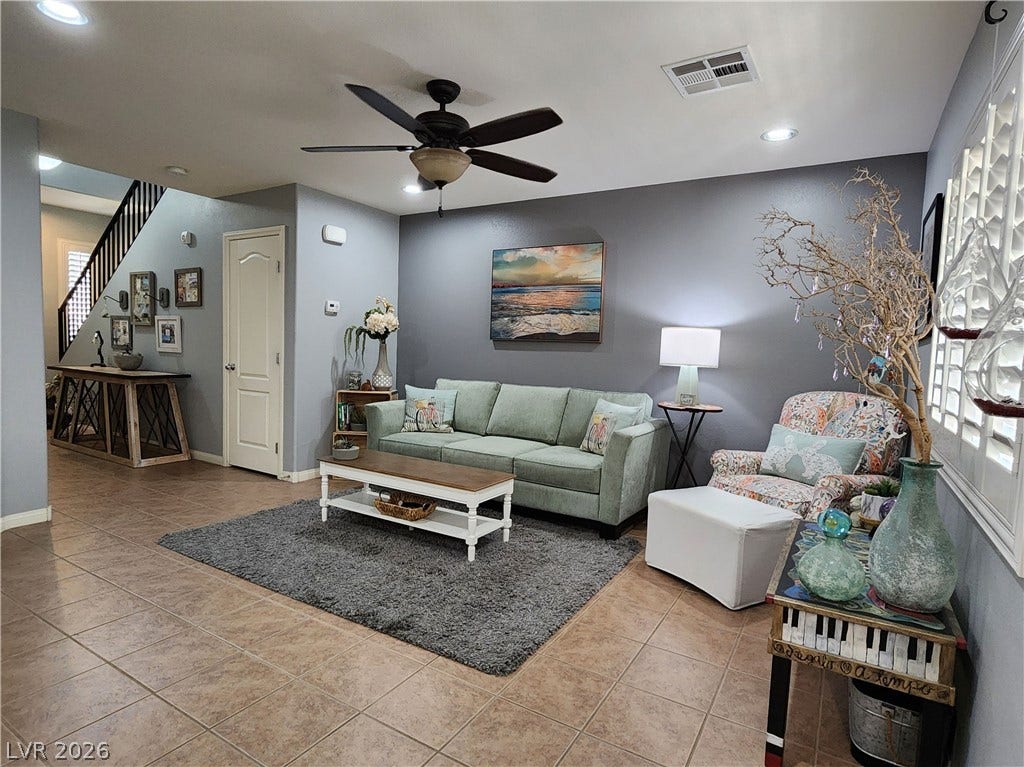 10549 Gibbous Moon Drive, Las Vegas, NV 89129 Tiled flooring and recessed lighting set a welcoming tone in this open living area.