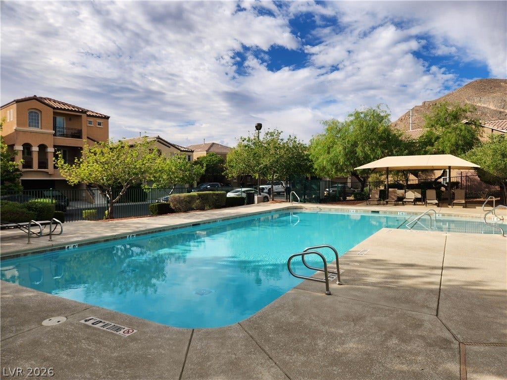10549 Gibbous Moon Drive, Las Vegas, NV 89129 An inviting community swimming pool sits surrounded by mountain views.