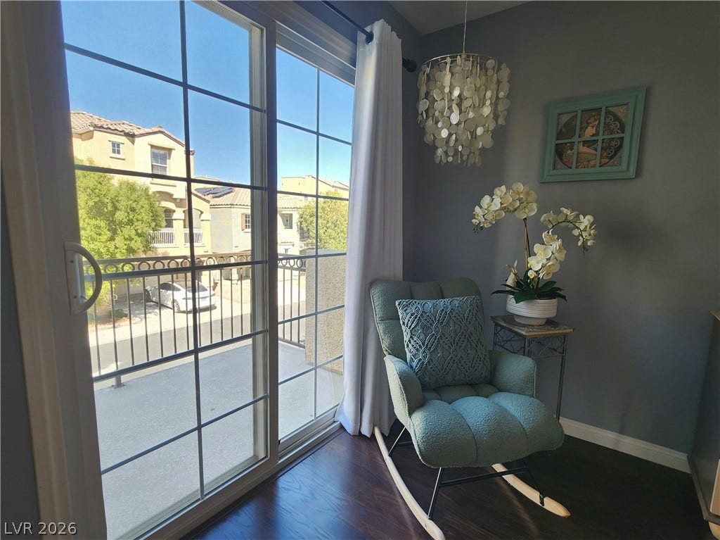 10549 Gibbous Moon Drive, Las Vegas, NV 89129 Large sliding glass doors open to a private balcony, filling the space with natural light.