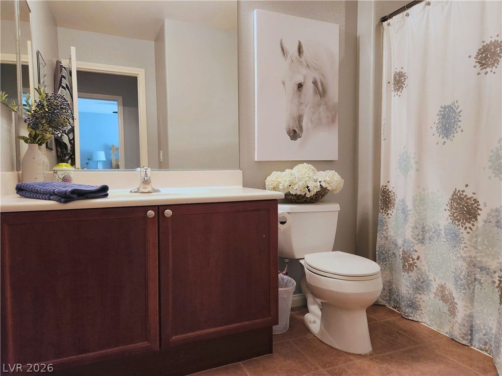 10549 Gibbous Moon Drive, Las Vegas, NV 89129 A spacious vanity and tile flooring highlight this functional bathroom space.