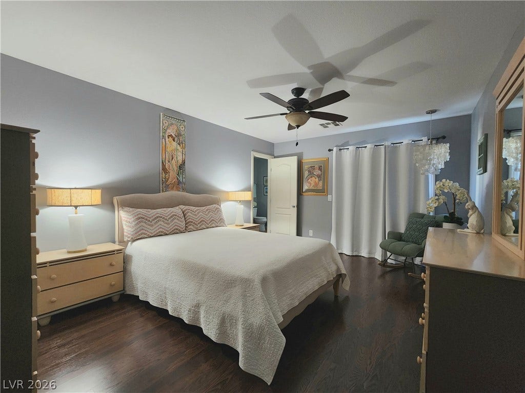 10549 Gibbous Moon Drive, Las Vegas, NV 89129 Polished wood floors and smooth walls create a quiet retreat in this private bedroom.