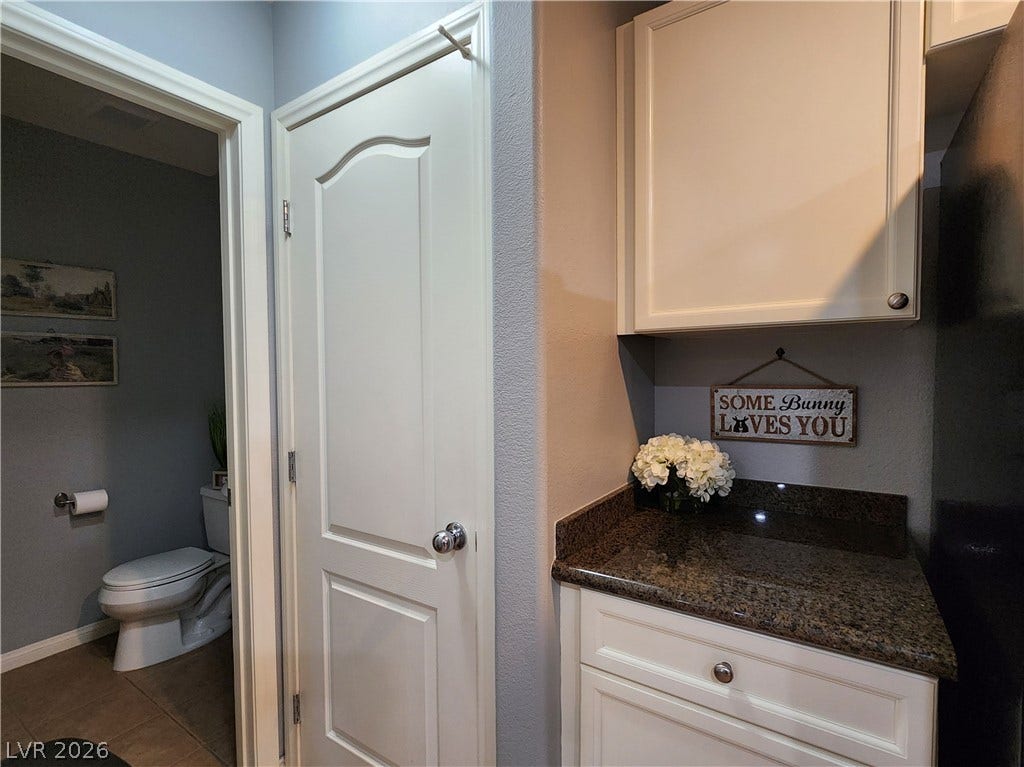 10549 Gibbous Moon Drive, Las Vegas, NV 89129 Polished granite countertops complement the clean white cabinetry and classic panel doors.