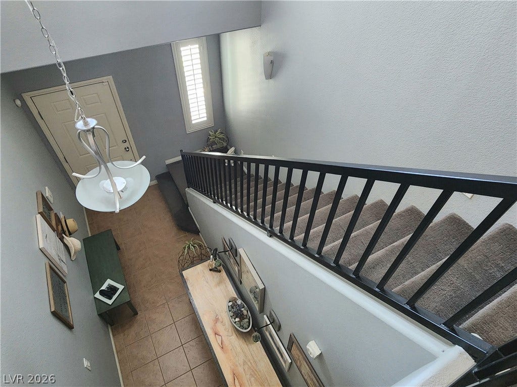 10549 Gibbous Moon Drive, Las Vegas, NV 89129 High ceilings and a prominent staircase define this welcoming multi-level entryway.