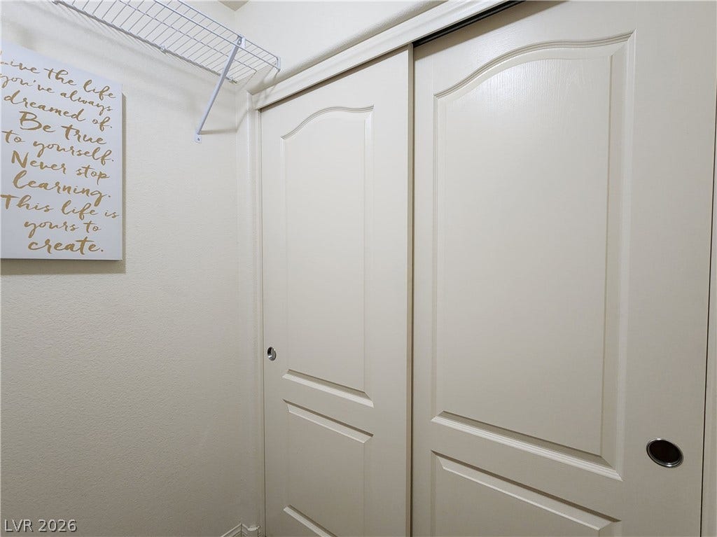 10549 Gibbous Moon Drive, Las Vegas, NV 89129 Sliding closet doors stand adjacent to built-in wire shelving.