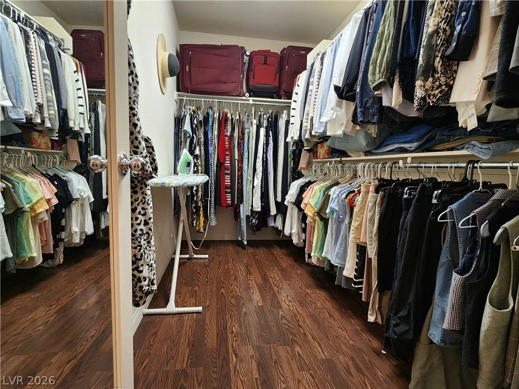 10549 Gibbous Moon Drive, Las Vegas, NV 89129 Rich wood flooring grounds this generous walk-in closet featuring extensive built-in storage rails.