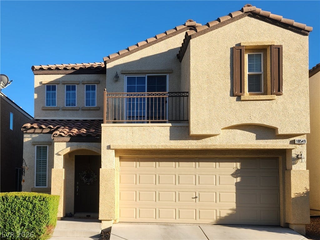 10549 Gibbous Moon Drive, Las Vegas, NV 89129 Spanish tile roofing and classic stucco exterior showcase timeless architectural appeal. Balcony off Primary Suite.