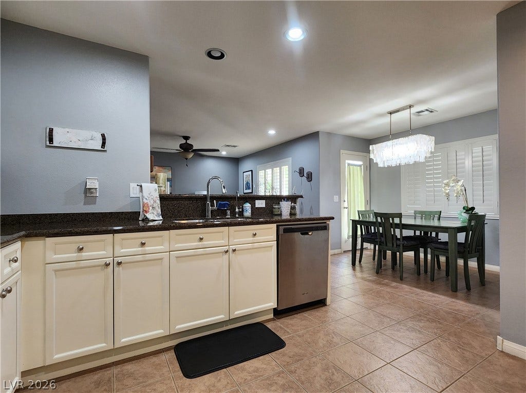 10549 Gibbous Moon Drive, Las Vegas, NV 89129 An open kitchen with granite countertops flows directly into the adjoining dining area.