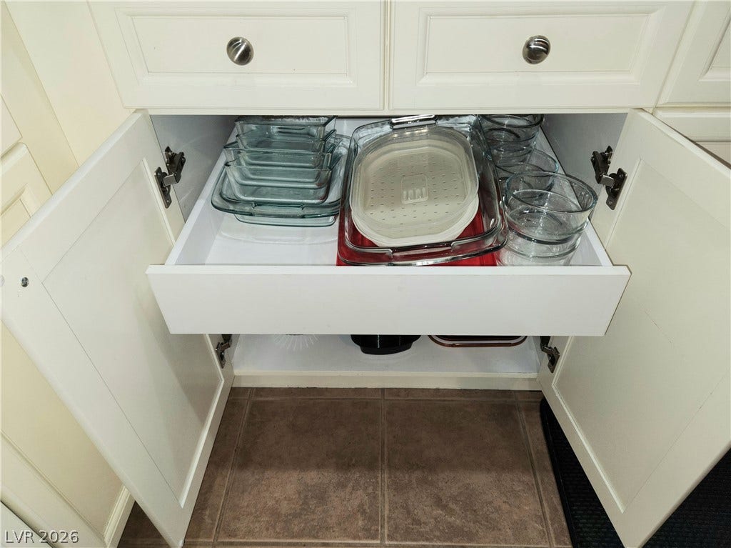 10549 Gibbous Moon Drive, Las Vegas, NV 89129 Custom cabinetry features convenient pull-out drawers for seamless organization.