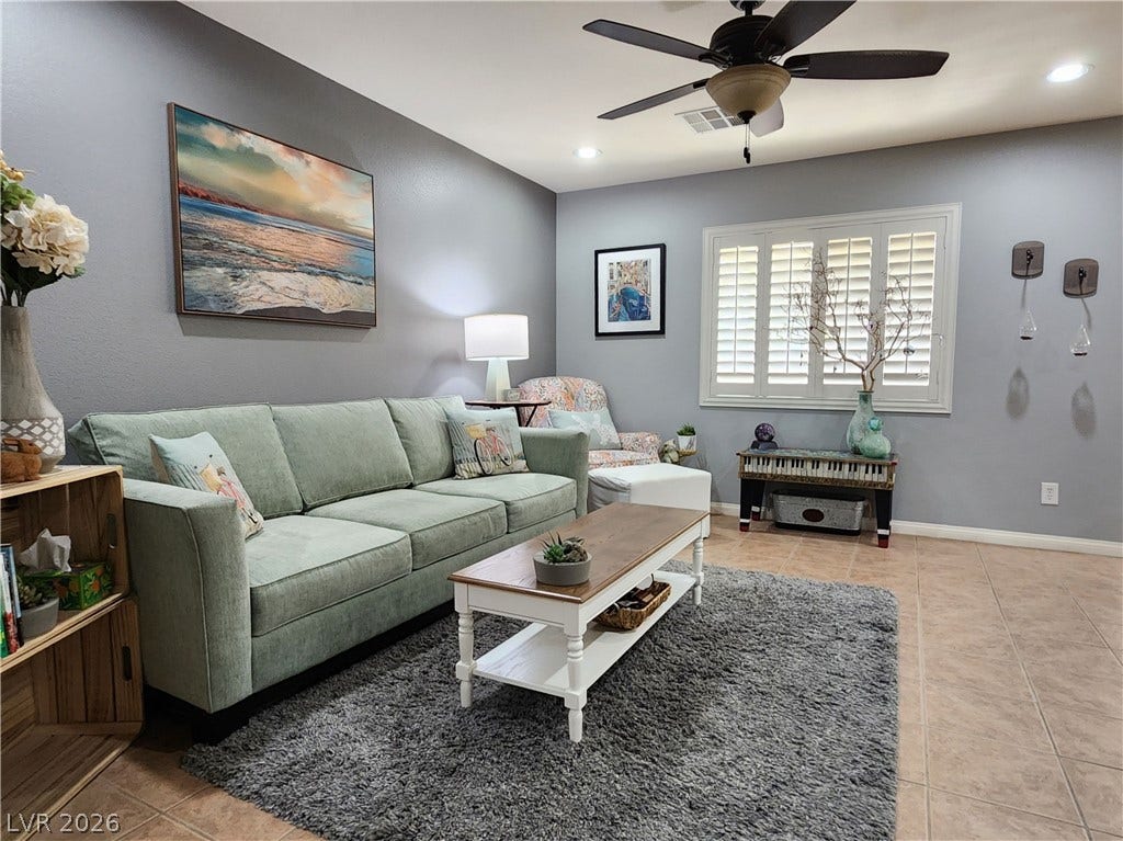 10549 Gibbous Moon Drive, Las Vegas, NV 89129 A spacious living area features tile flooring, recessed lighting, and plantation shutters.