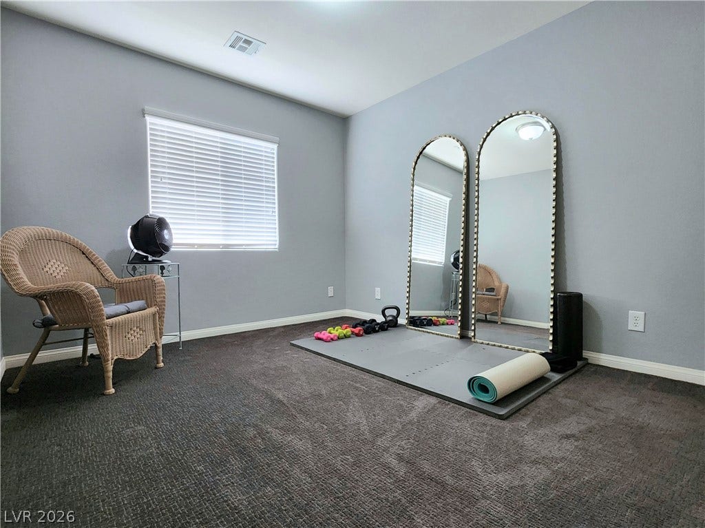10549 Gibbous Moon Drive, Las Vegas, NV 89129 A versatile space features wall-to-wall carpeting and a wide window with integrated blinds.