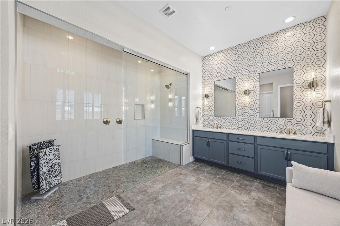3382 Spring Rock Avenue, Henderson, NV 89044 A spacious bathroom features an expansive walk-in shower and a double vanity.