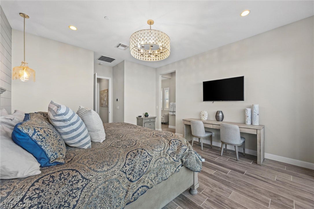 3382 Spring Rock Avenue, Henderson, NV 89044 Recessed lighting and a distinctive chandelier illuminate this serene space with wood-look tile flooring.