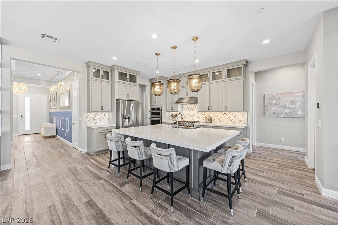 3382 Spring Rock Avenue, Henderson, NV 89044 An expansive central island grounds this contemporary culinary space under high ceilings and recessed lighting.