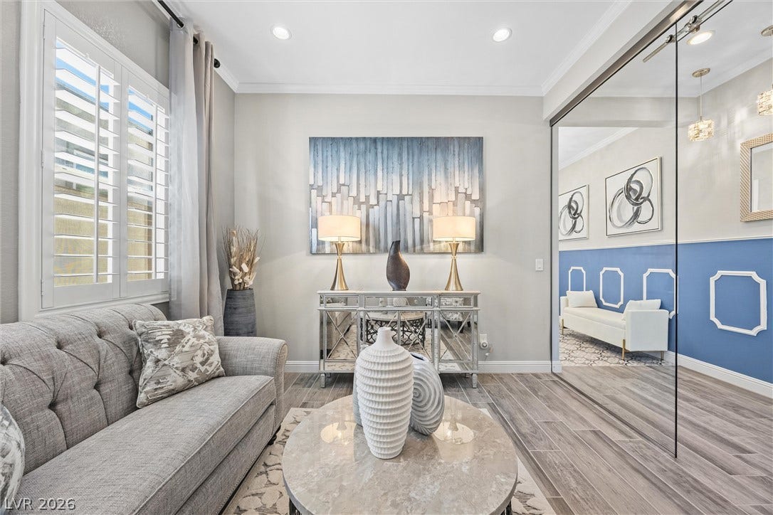 3382 Spring Rock Avenue, Henderson, NV 89044 Warm wood-look tile flooring and recessed lighting define this inviting, light-filled sitting area.
