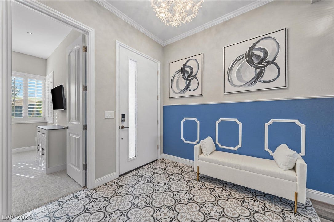 3382 Spring Rock Avenue, Henderson, NV 89044 Patterned tile flooring and wainscoting details welcome guests inside this elegant entrance foyer.