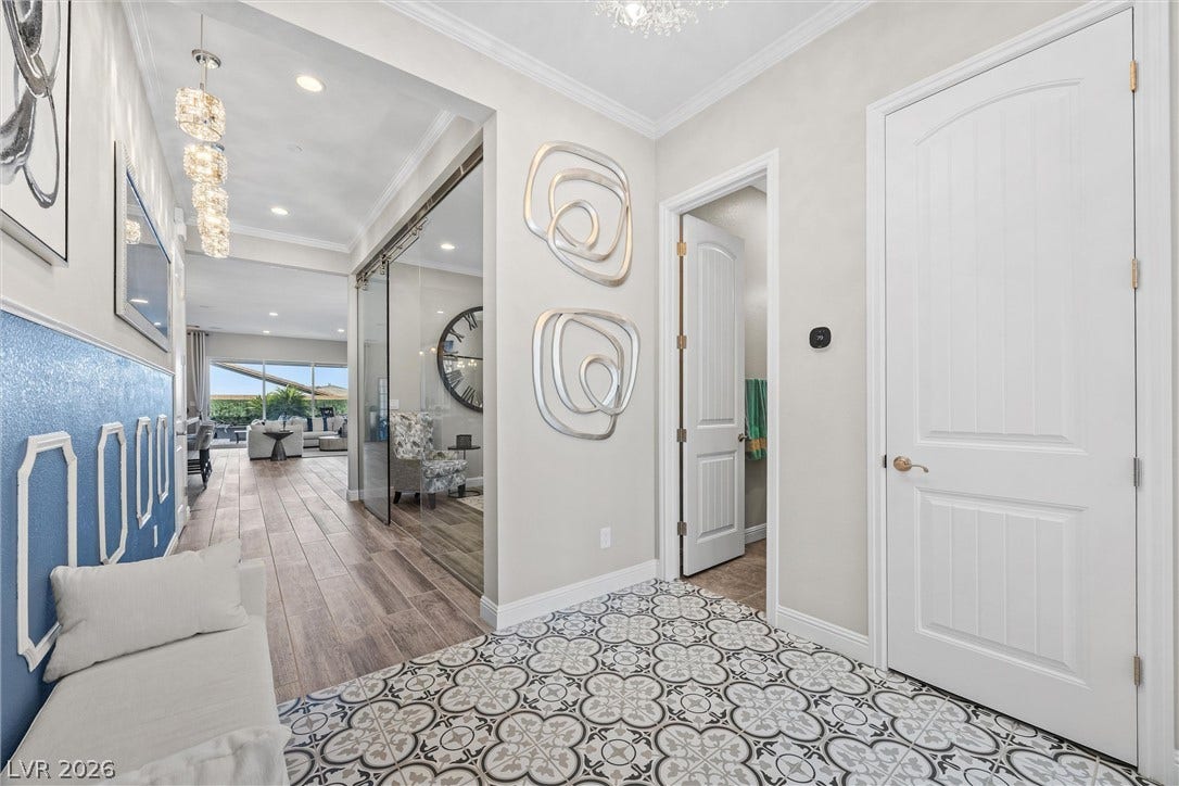 3382 Spring Rock Avenue, Henderson, NV 89044 Gleaming patterned tile transitions to warm wood flooring under elegant crown molding.