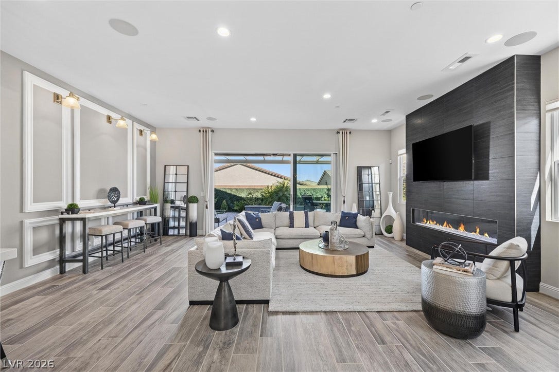 3382 Spring Rock Avenue, Henderson, NV 89044 An open floorplan centers around a modern linear fireplace under recessed lighting.
