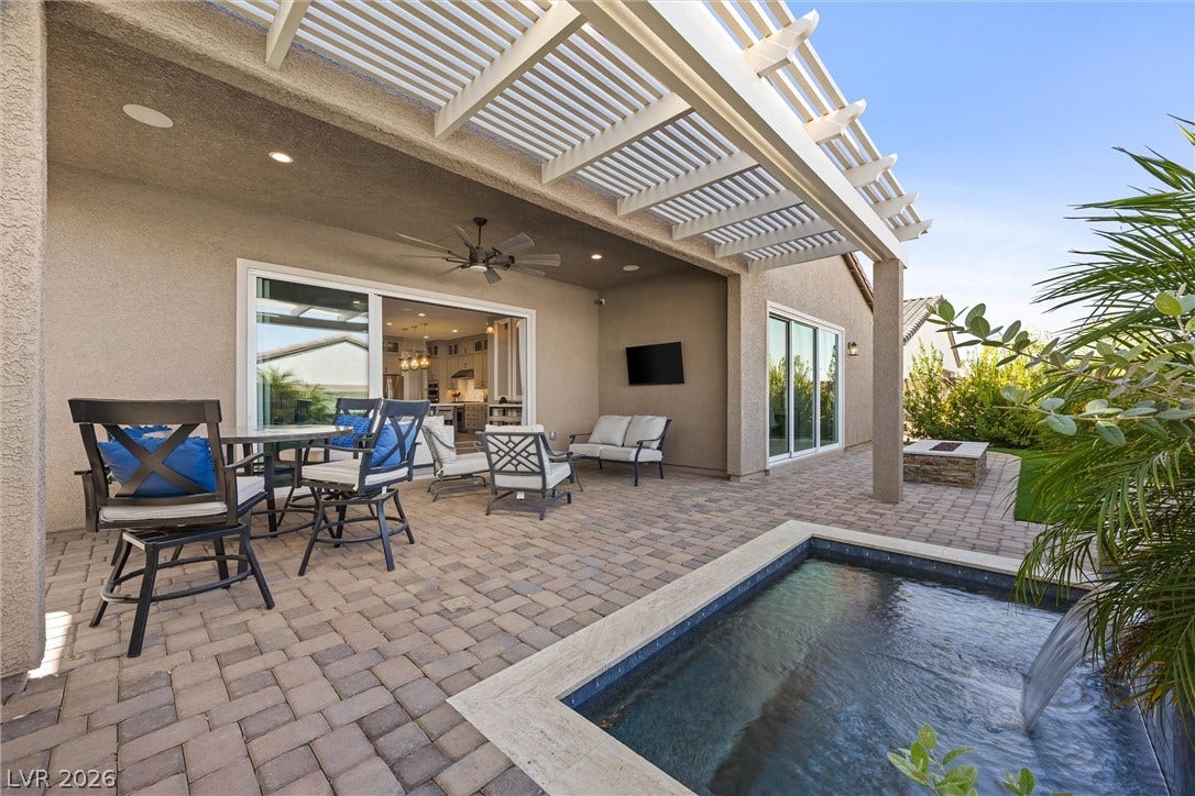 3382 Spring Rock Avenue, Henderson, NV 89044 A spacious paved patio features a built-in spa, a shaded pergola, and smooth stucco finishes.