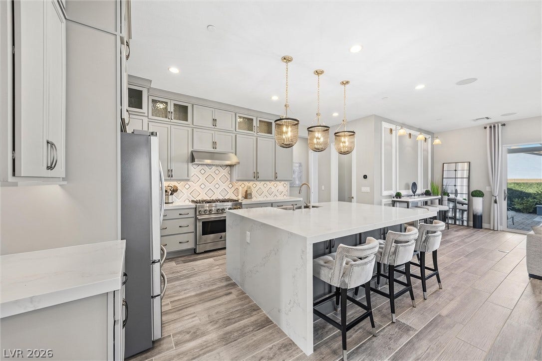 3382 Spring Rock Avenue, Henderson, NV 89044 An expansive kitchen features high-end finishes, modern cabinetry, and a large central island.