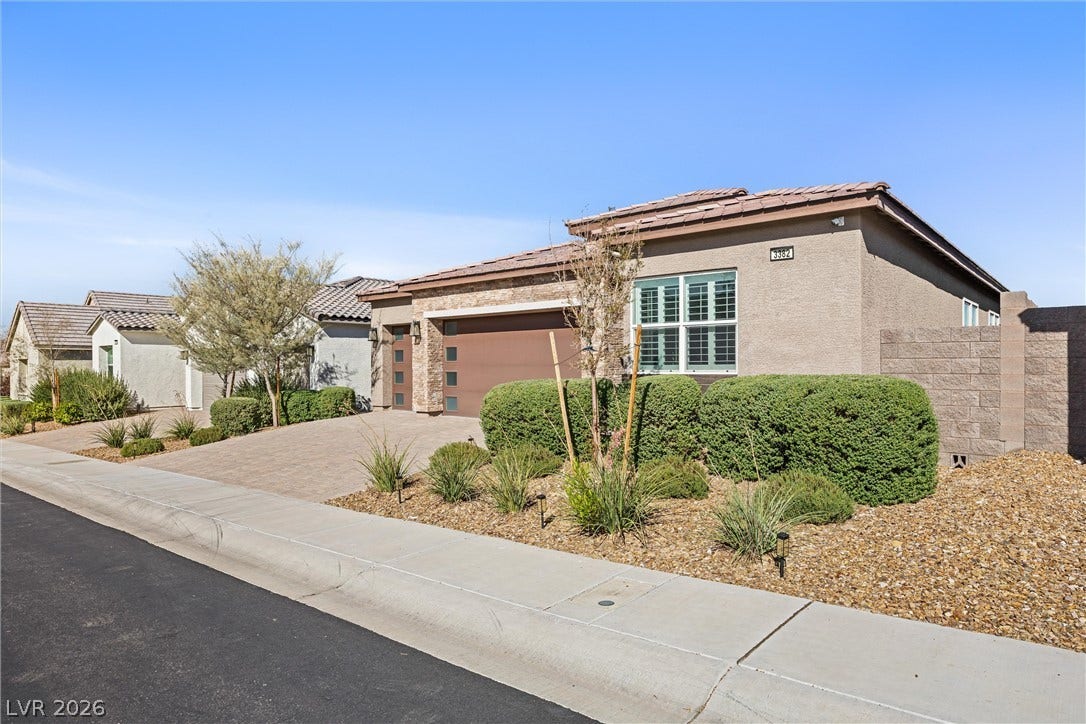 3382 Spring Rock Avenue, Henderson, NV 89044 Manicured desert landscaping enhances the modern stucco facade of this single-story residence.