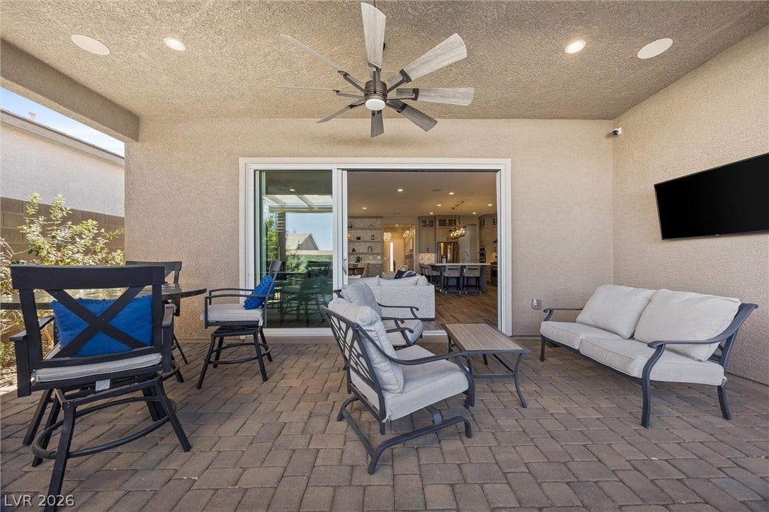 3382 Spring Rock Avenue, Henderson, NV 89044 An inviting covered patio features neat stone pavers and transitions seamlessly to the interior.