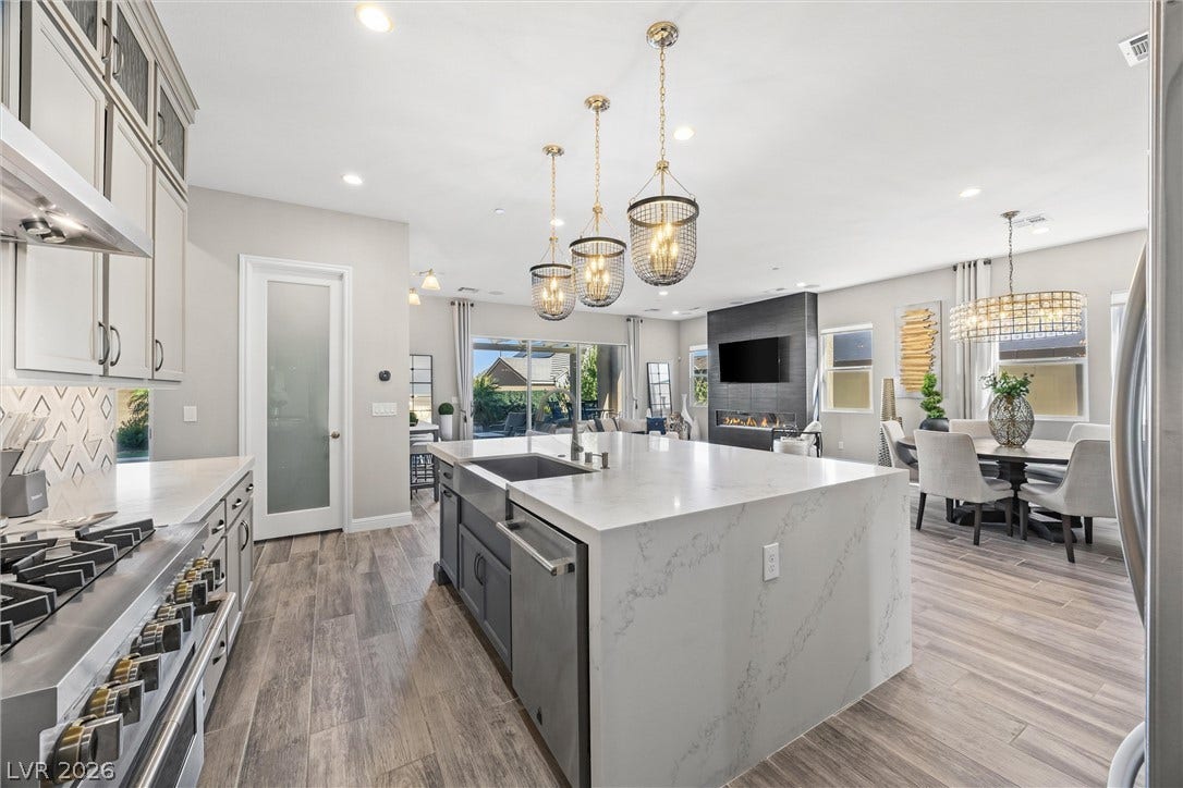 3382 Spring Rock Avenue, Henderson, NV 89044 An open floorplan seamlessly connects the stone-countertop kitchen island to the bright living areas.