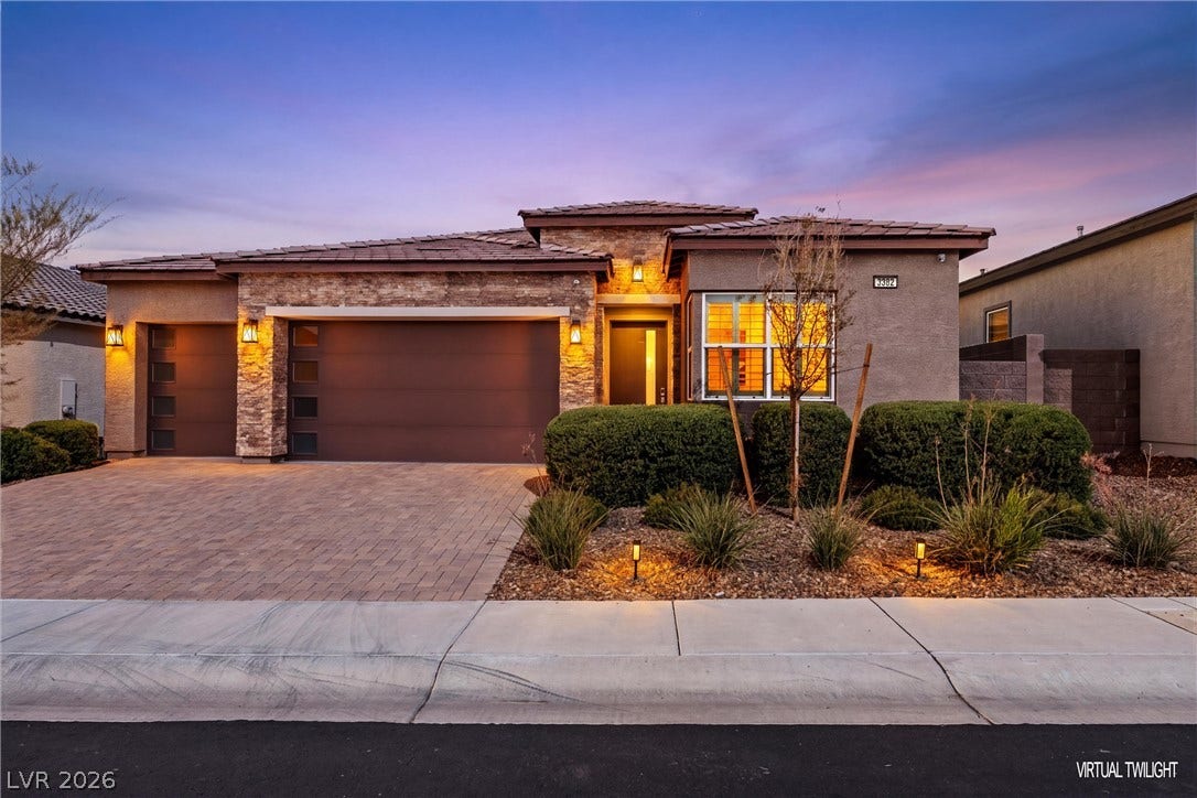 3382 Spring Rock Avenue, Henderson, NV 89044 Textured stone accents and a paver driveway enhance this modern single-story residence.